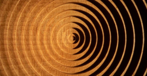 orange and black geometric pattern in a circular shape