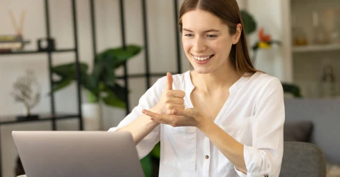 woman sign language in front of laptop