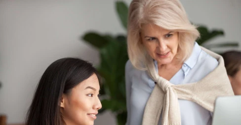two women looking at laptop